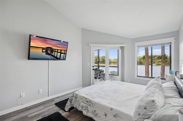 bedroom featuring baseboards, vaulted ceiling, and wood finished floors