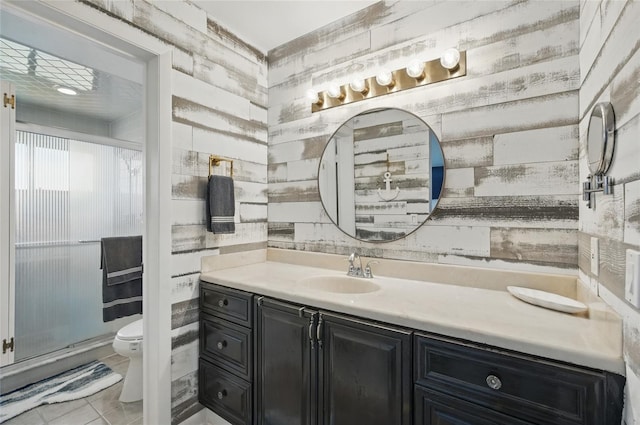 bathroom featuring vanity, tile patterned floors, and toilet