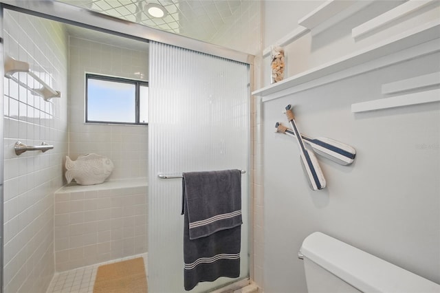 full bath with a stall shower and toilet