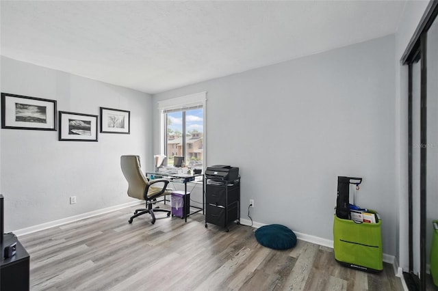 office featuring baseboards and wood finished floors