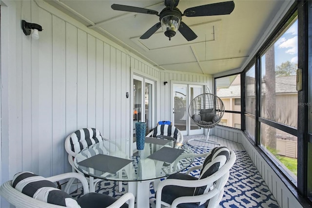 sunroom / solarium with french doors, plenty of natural light, and a ceiling fan