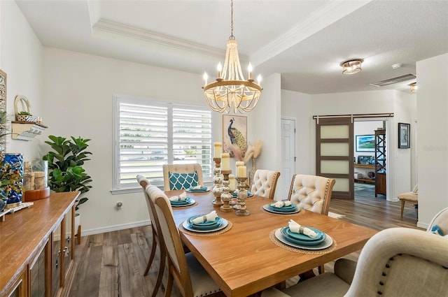 dining room with a notable chandelier, baseboards, dark wood finished floors, visible vents, and crown molding