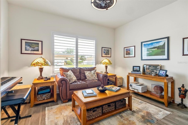 sitting room featuring baseboards and wood finished floors