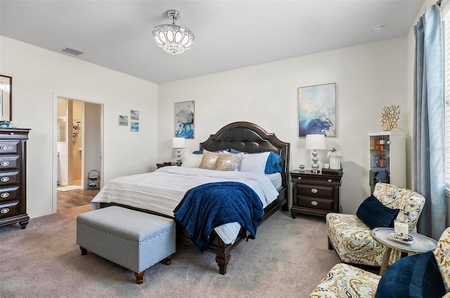 carpeted bedroom featuring connected bathroom and visible vents