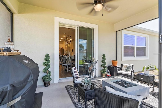 view of patio featuring an outdoor living space with a fire pit, ceiling fan, and grilling area