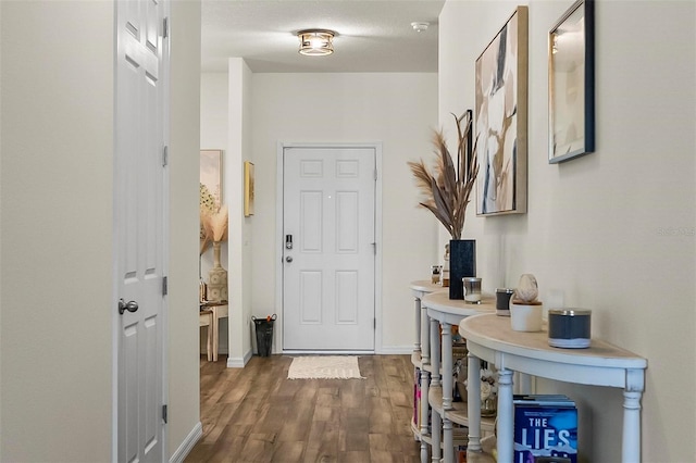 interior space with baseboards and wood finished floors