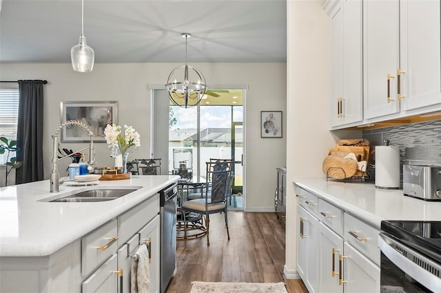 kitchen featuring a sink, wood finished floors, an inviting chandelier, light countertops, and stainless steel dishwasher