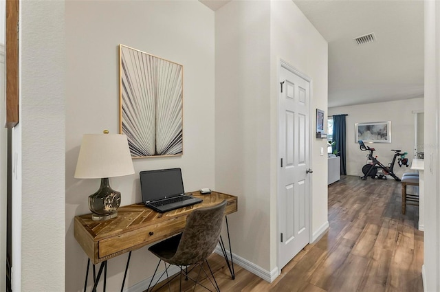 office space featuring visible vents, wood finished floors, and baseboards