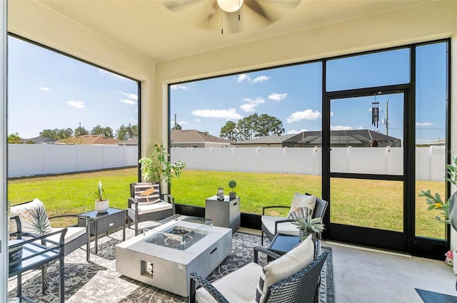 sunroom / solarium with an outdoor living space with a fire pit and a ceiling fan