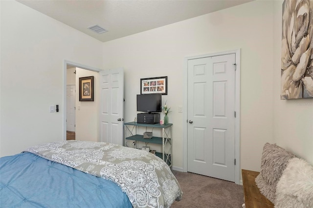 bedroom featuring baseboards, visible vents, and carpet