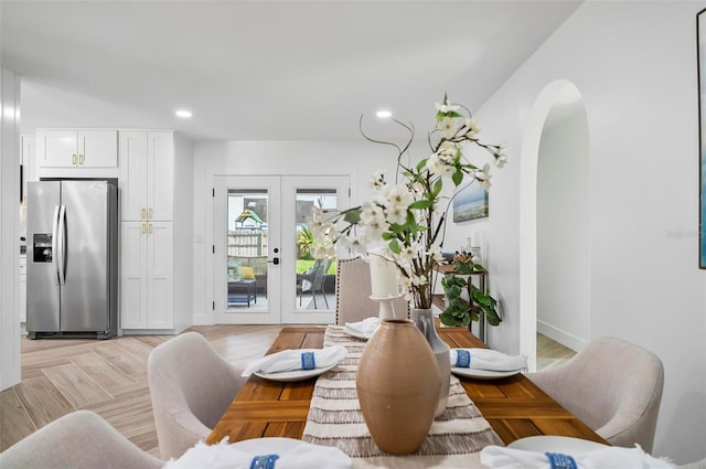 104 Foxhall Ln, Palm Coast, FL 32137 - dining room featuring arched walkways, french doors, recessed lighting, and baseboards