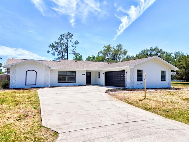 104 Foxhall Ln, Palm Coast, FL 32137 - ranch-style home with driveway, an attached garage, a front lawn, and stucco siding
