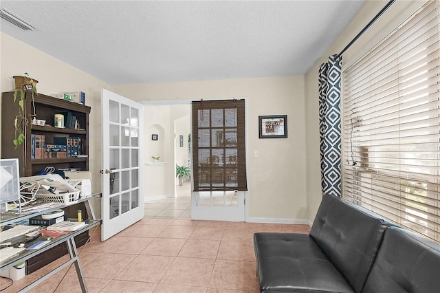 237 N Hidden Tree Dr, Saint Augustine, FL 32086 - sitting room featuring a textured ceiling, light tile patterned flooring, and french doors