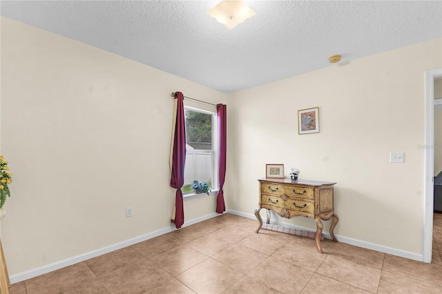 237 N Hidden Tree Dr, Saint Augustine, FL 32086 - empty room featuring a textured ceiling, a smoke detector, and light tile patterned floors