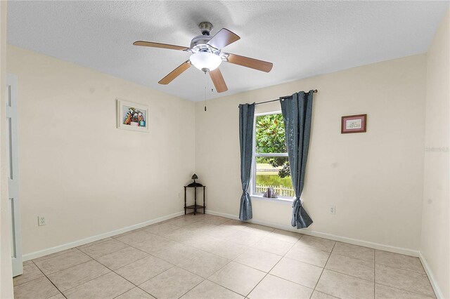 237 N Hidden Tree Dr, Saint Augustine, FL 32086 - empty room featuring light tile patterned floors, ceiling fan, and a textured ceiling