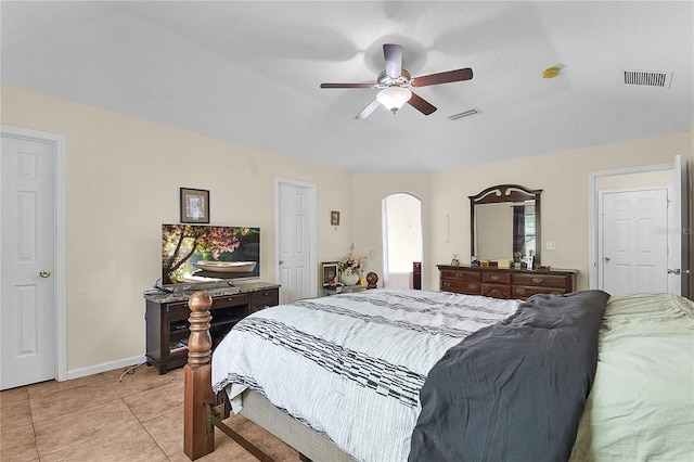 237 N Hidden Tree Dr, Saint Augustine, FL 32086 - bedroom with arched walkways, light tile patterned floors, and a ceiling fan