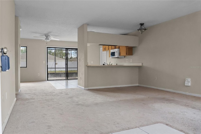 14 Post Oak Ln, Palm Coast, FL 32164 - unfurnished living room with carpet, ceiling fan, and baseboards