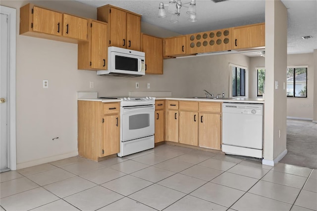 14 Post Oak Ln, Palm Coast, FL 32164 - kitchen with white appliances, a sink, light countertops, baseboards, and light tile patterned floors