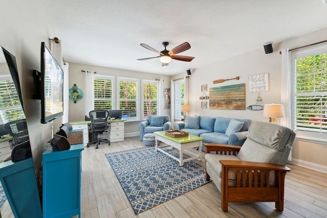 living room with an office area, ceiling fan, plenty of natural light, and wood finished floors