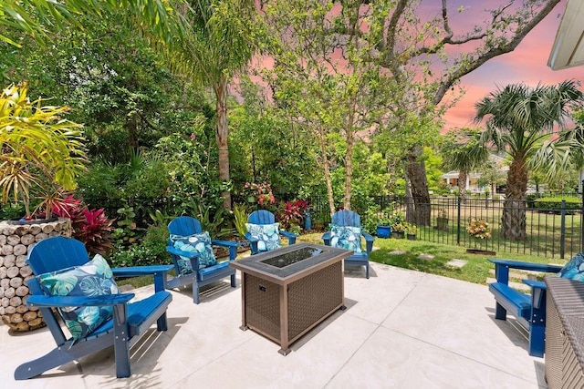 view of patio with fence and a fire pit