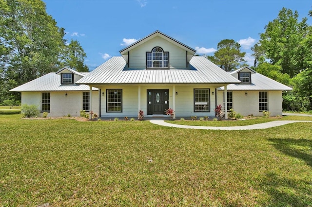 view of front facade featuring metal roof, a porch, and a front yard