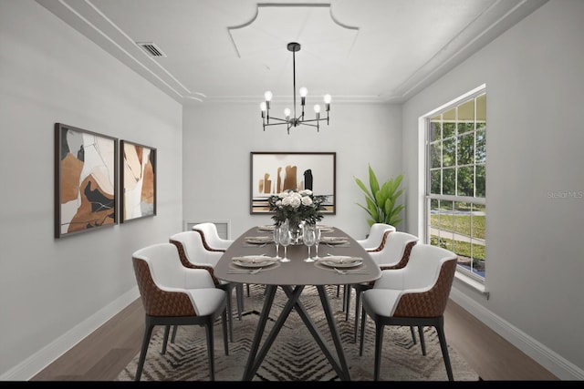 dining room featuring baseboards, a chandelier, visible vents, and wood finished floors