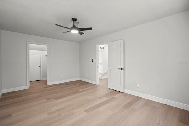 unfurnished bedroom featuring baseboards, light wood-style floors, and ceiling fan