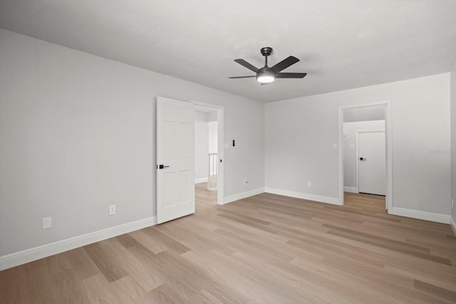 unfurnished bedroom with light wood-style floors, baseboards, and a ceiling fan