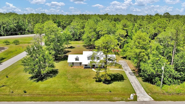 birds eye view of property featuring a wooded view