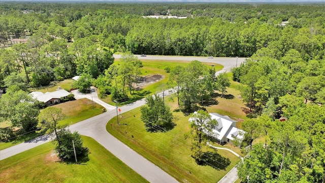 birds eye view of property featuring a wooded view