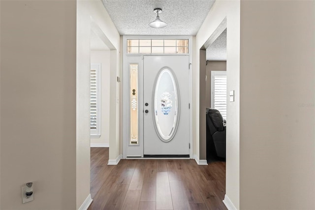 49 Louisiana Dr, Palm Coast, FL 32137 - entrance foyer with baseboards, a textured ceiling, and dark wood-style flooring