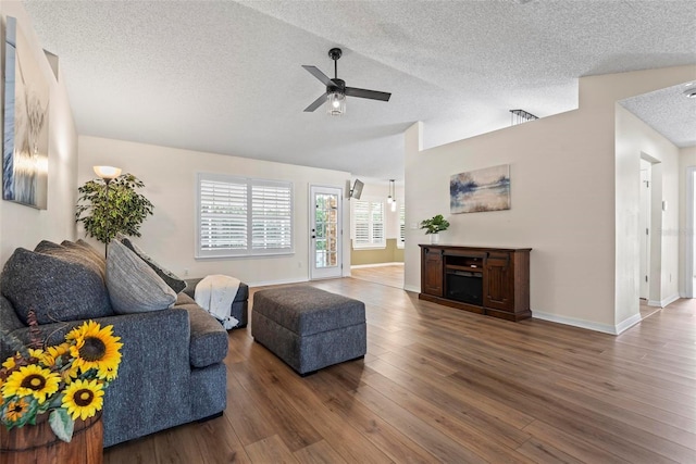 49 Louisiana Dr, Palm Coast, FL 32137 - living room with a textured ceiling, a ceiling fan, wood finished floors, vaulted ceiling, and baseboards