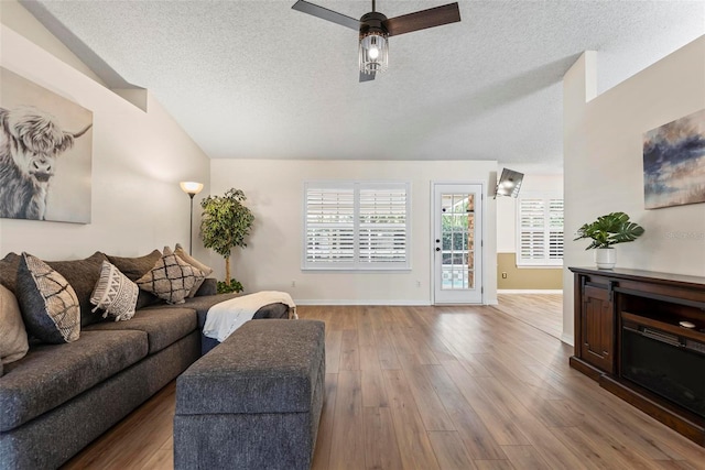 49 Louisiana Dr, Palm Coast, FL 32137 - living area featuring vaulted ceiling, a textured ceiling, wood finished floors, baseboards, and ceiling fan