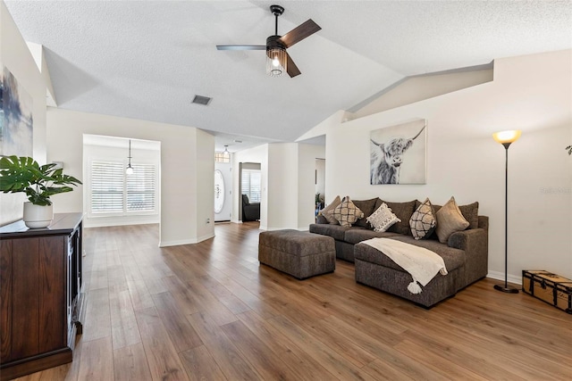 49 Louisiana Dr, Palm Coast, FL 32137 - living area featuring ceiling fan, lofted ceiling, wood finished floors, and baseboards
