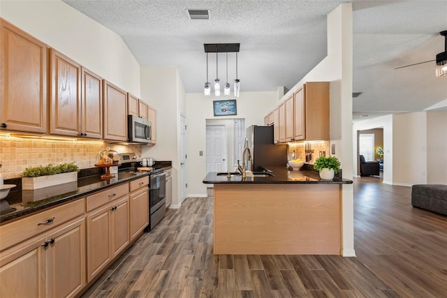 49 Louisiana Dr, Palm Coast, FL 32137 - kitchen featuring stainless steel appliances, a sink, dark wood-style floors, and decorative backsplash