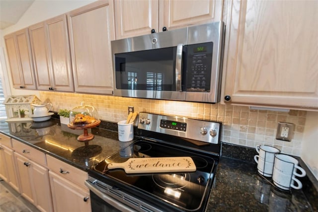 49 Louisiana Dr, Palm Coast, FL 32137 - kitchen with appliances with stainless steel finishes, tasteful backsplash, and dark stone countertops