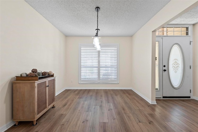 49 Louisiana Dr, Palm Coast, FL 32137 - foyer featuring a textured ceiling, wood finished floors, and baseboards