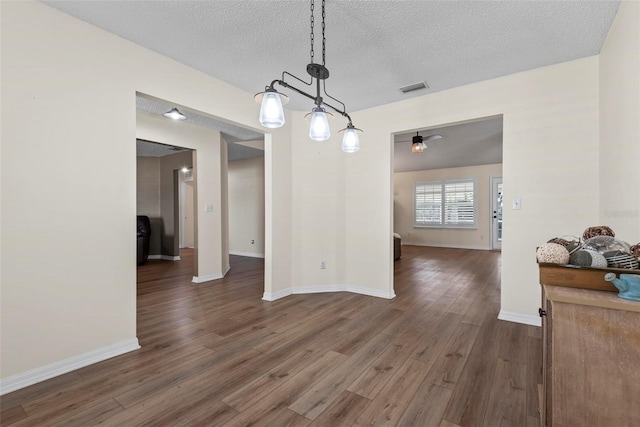 49 Louisiana Dr, Palm Coast, FL 32137 - dining space featuring wood finished floors, baseboards, a textured ceiling, and a ceiling fan