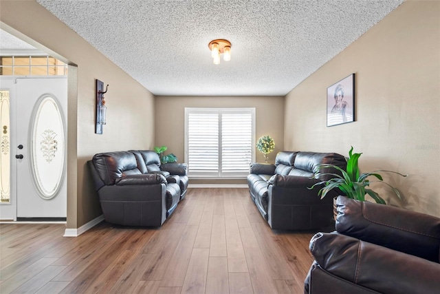 49 Louisiana Dr, Palm Coast, FL 32137 - living room with a textured ceiling, wood finished floors, and baseboards