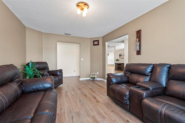 49 Louisiana Dr, Palm Coast, FL 32137 - living area with light wood-type flooring, a textured ceiling, and baseboards