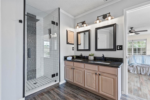 49 Louisiana Dr, Palm Coast, FL 32137 - ensuite bathroom featuring a textured ceiling, wood finished floors, a shower stall, a ceiling fan, and double vanity