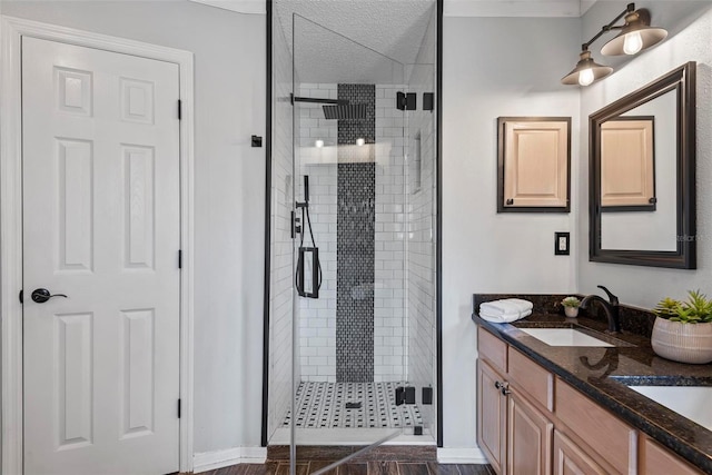 49 Louisiana Dr, Palm Coast, FL 32137 - full bathroom featuring a shower stall, double vanity, baseboards, and a textured ceiling