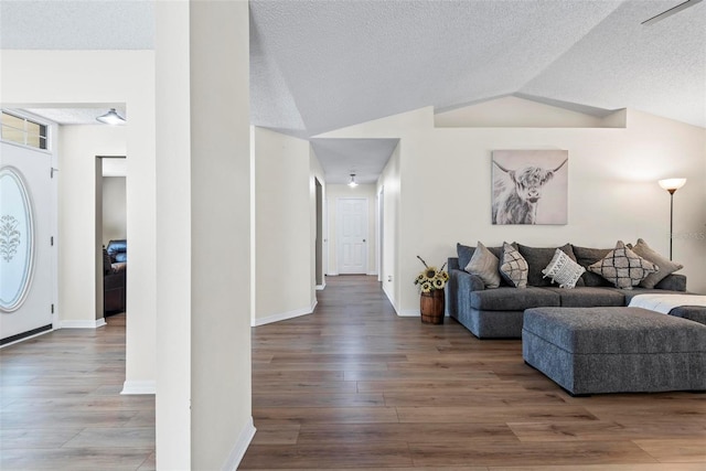 49 Louisiana Dr, Palm Coast, FL 32137 - living area featuring wood finished floors, a textured ceiling, lofted ceiling, and baseboards