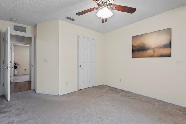 49 Louisiana Dr, Palm Coast, FL 32137 - unfurnished bedroom featuring carpet flooring, baseboards, a textured ceiling, and a ceiling fan