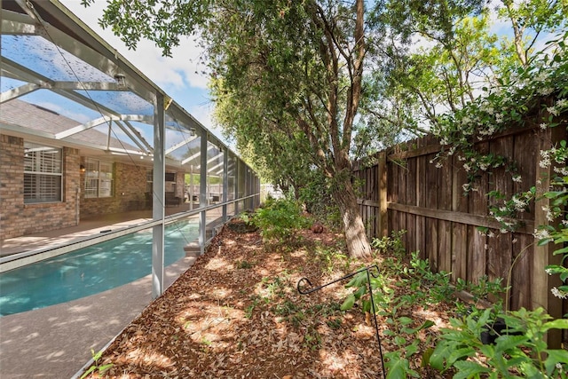 49 Louisiana Dr, Palm Coast, FL 32137 - view of pool featuring fence, glass enclosure, and a patio area