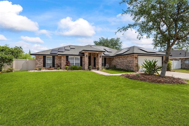 49 Louisiana Dr, Palm Coast, FL 32137 - view of front of house featuring driveway, roof mounted solar panels, a garage, a gate, and roof with shingles