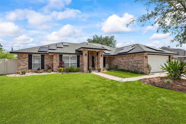 49 Louisiana Dr, Palm Coast, FL 32137 - view of front of house featuring roof mounted solar panels, brick siding, a garage, and roof with shingles