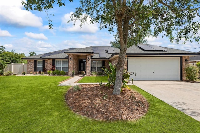 49 Louisiana Dr, Palm Coast, FL 32137 - view of front facade featuring an attached garage, driveway, solar panels, brick siding, and a shingled roof