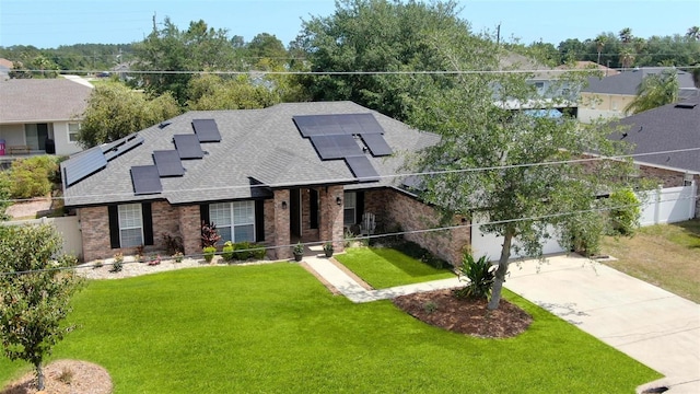 49 Louisiana Dr, Palm Coast, FL 32137 - view of front of property with brick siding, a shingled roof, concrete driveway, and solar panels
