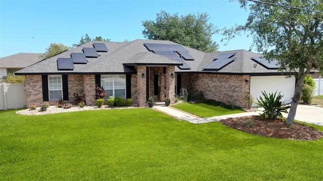 49 Louisiana Dr, Palm Coast, FL 32137 - view of front of home featuring brick siding, a shingled roof, solar panels, and a garage